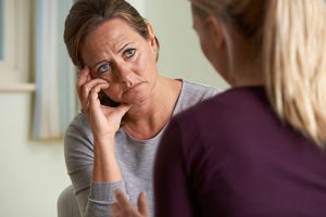 Upset woman meeting with counselor