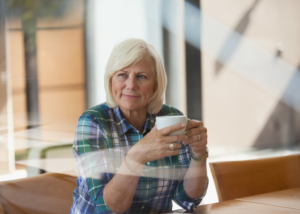 Middle aged woman at a table looking thoughtful