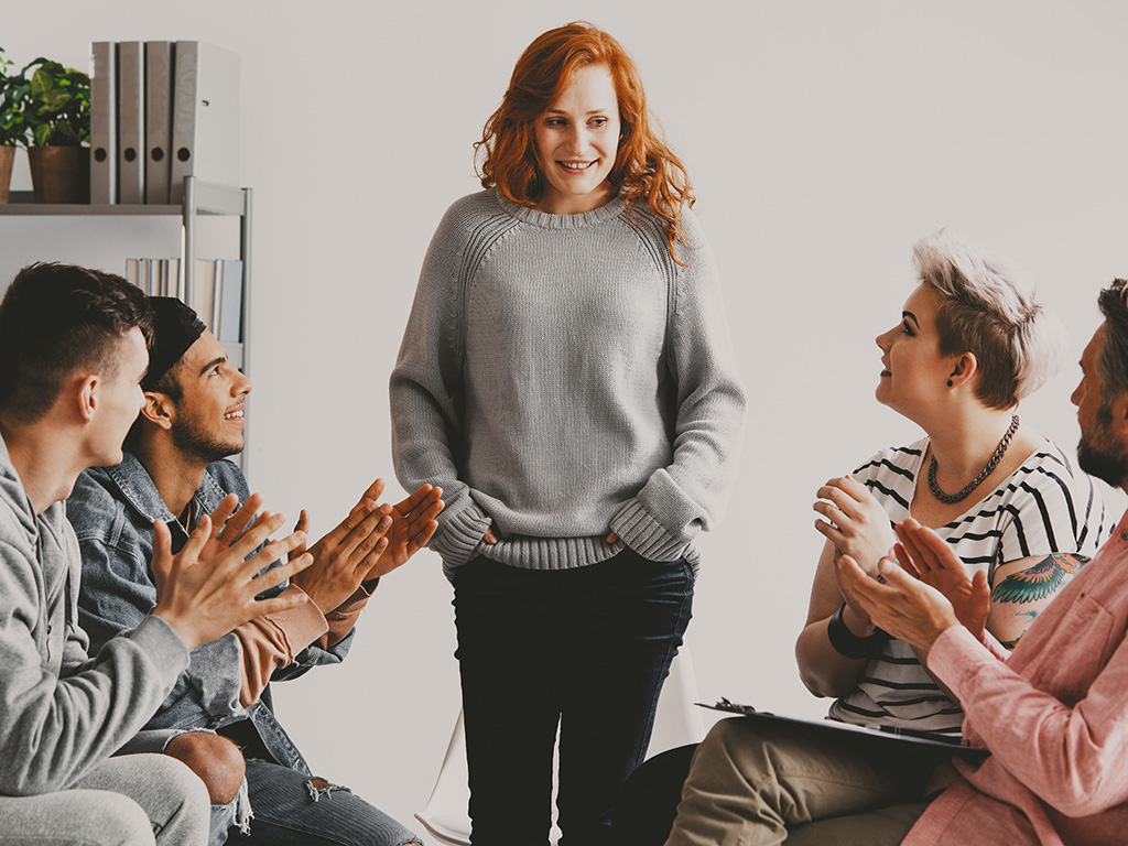 woman-standing-in-front-of-group